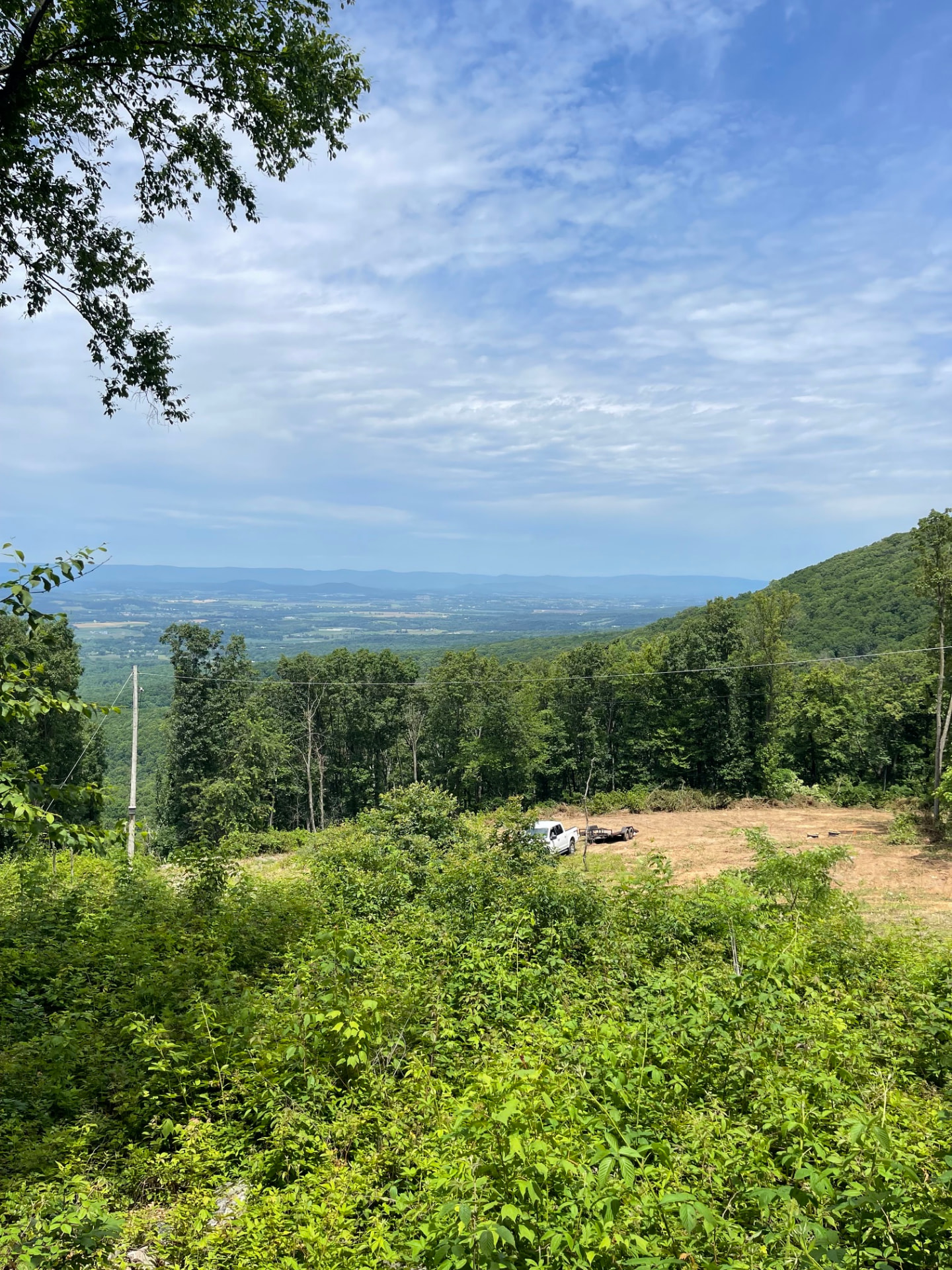 The cleared building site on the mountaintop looking west over the valley